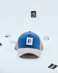 Front view of Blue and Beige Customisable Trucker Cap with patches