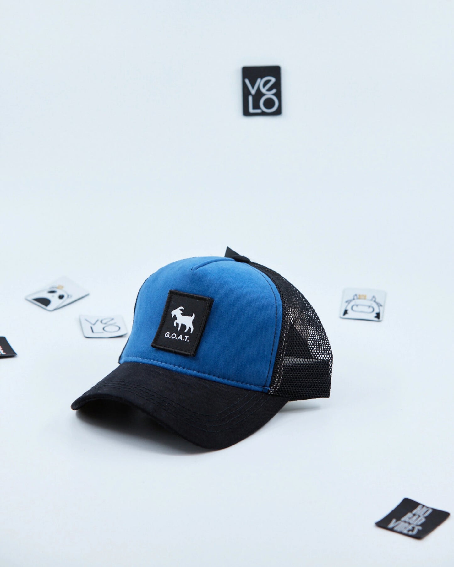 Side view of Blue and Black Customisable Trucker Cap with patches