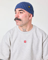 side view of a man wearing Blue Fisherman Beanie