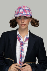 Person wearing Born In Earth Pink Casket Hat and tie with a plain background