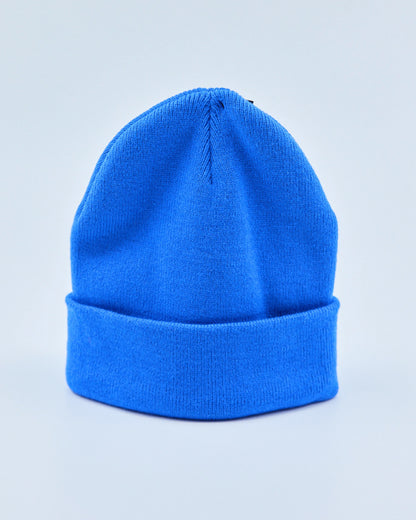 Bright blue beanie on a light gray background