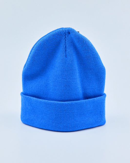 Bright blue beanie on a light gray background