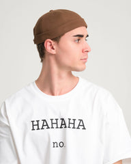 man wearing brown docker cap