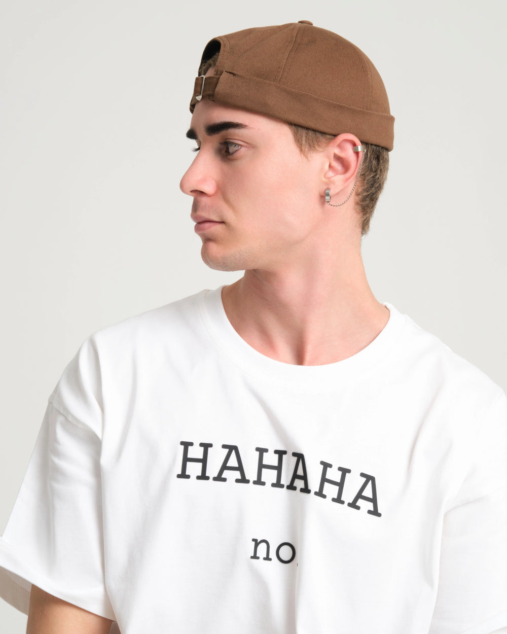 man wearing brown docker cap hat