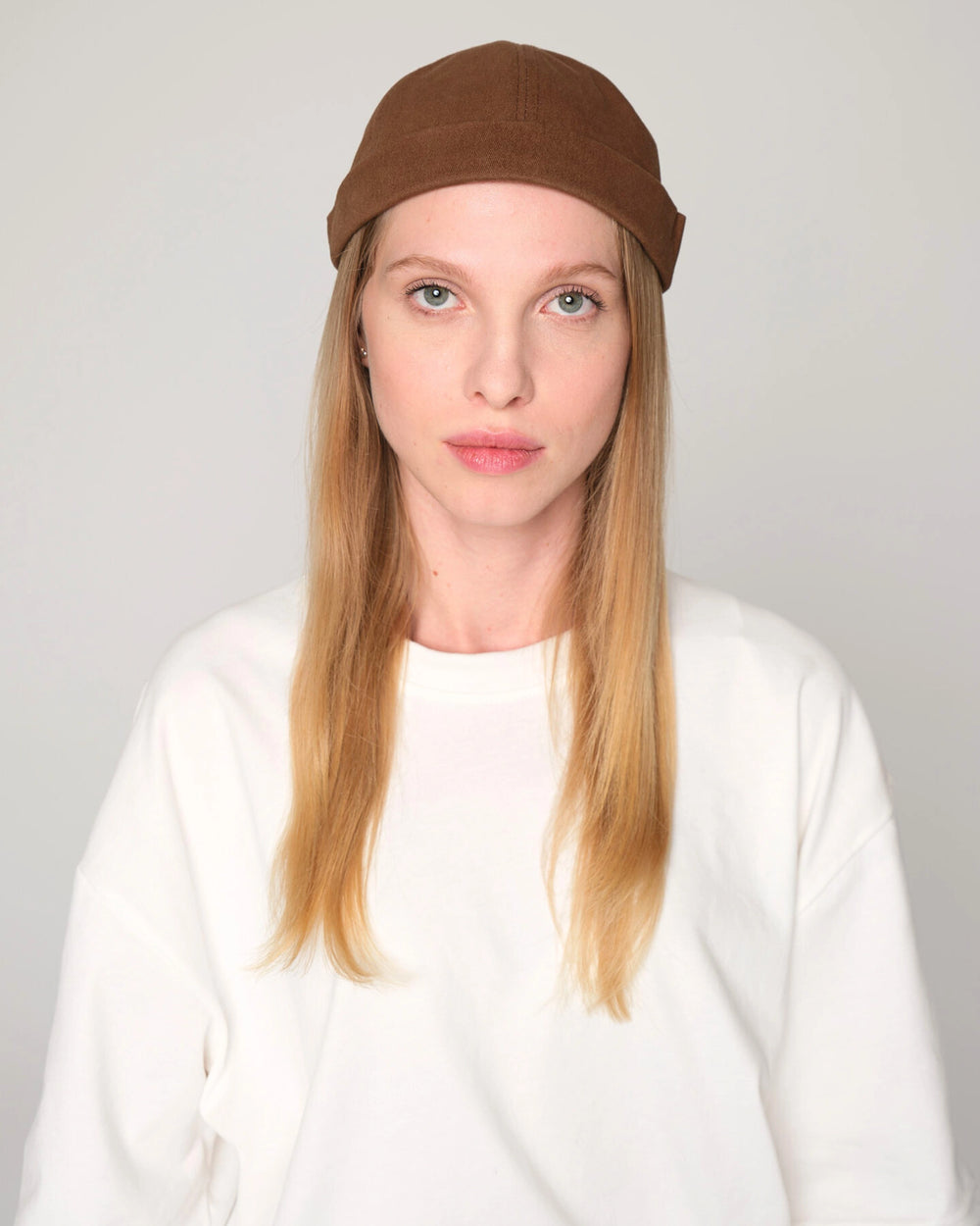 woman wearing brown docker cap hat