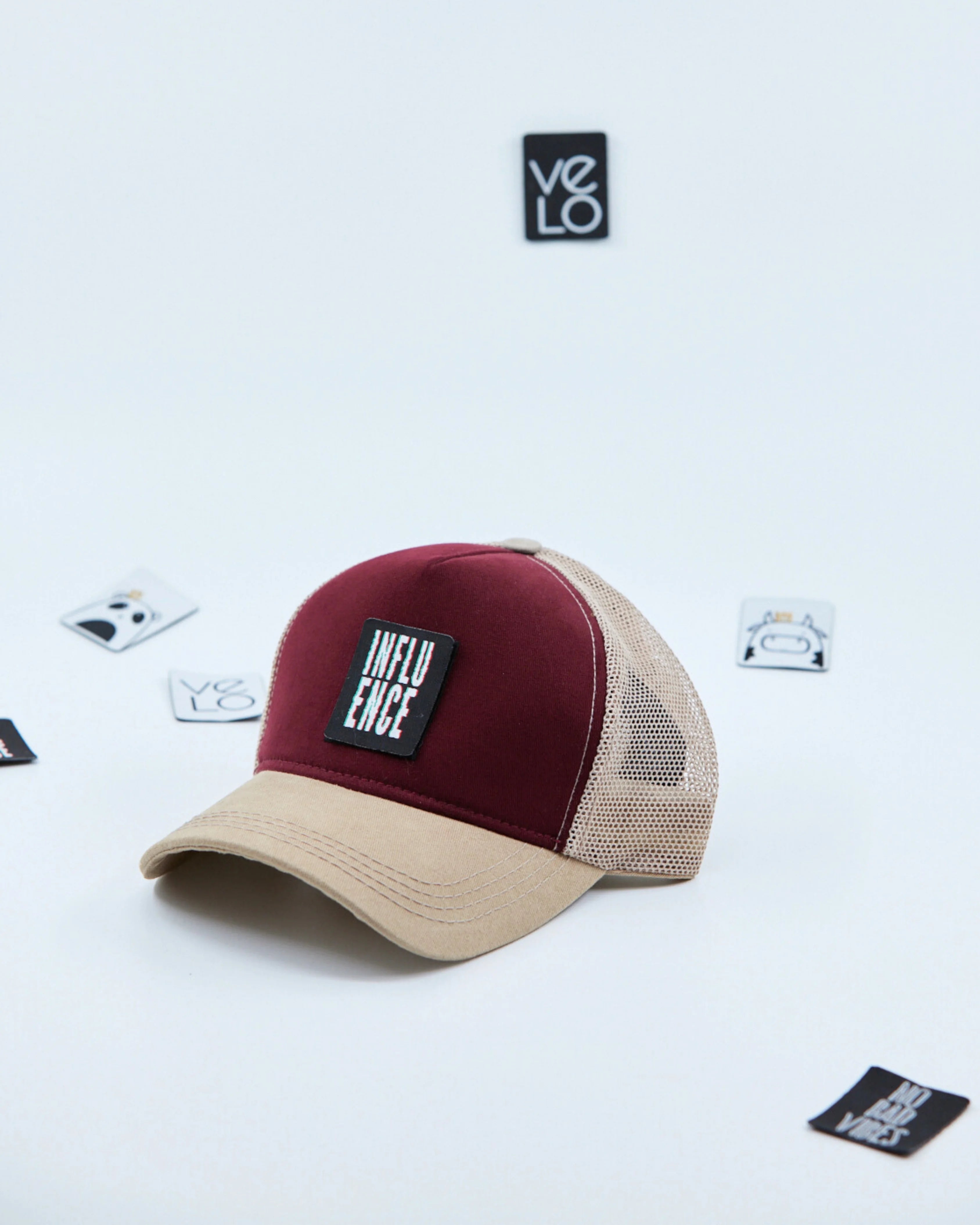 Side view of Burgundy and Beige Trucker Cap with patches