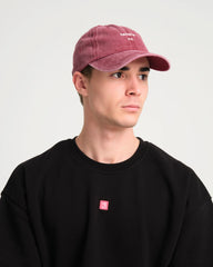 side view of man wearing Hahaha No Burgundy Washed Cap