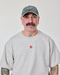 front view of a man wearing Cute But Psycho Dark Green Washed Cap