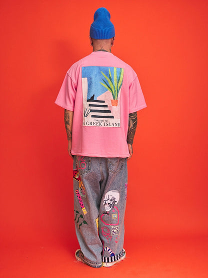 Person wearing a pink t-shirt with a graphic design on the back against an orange background