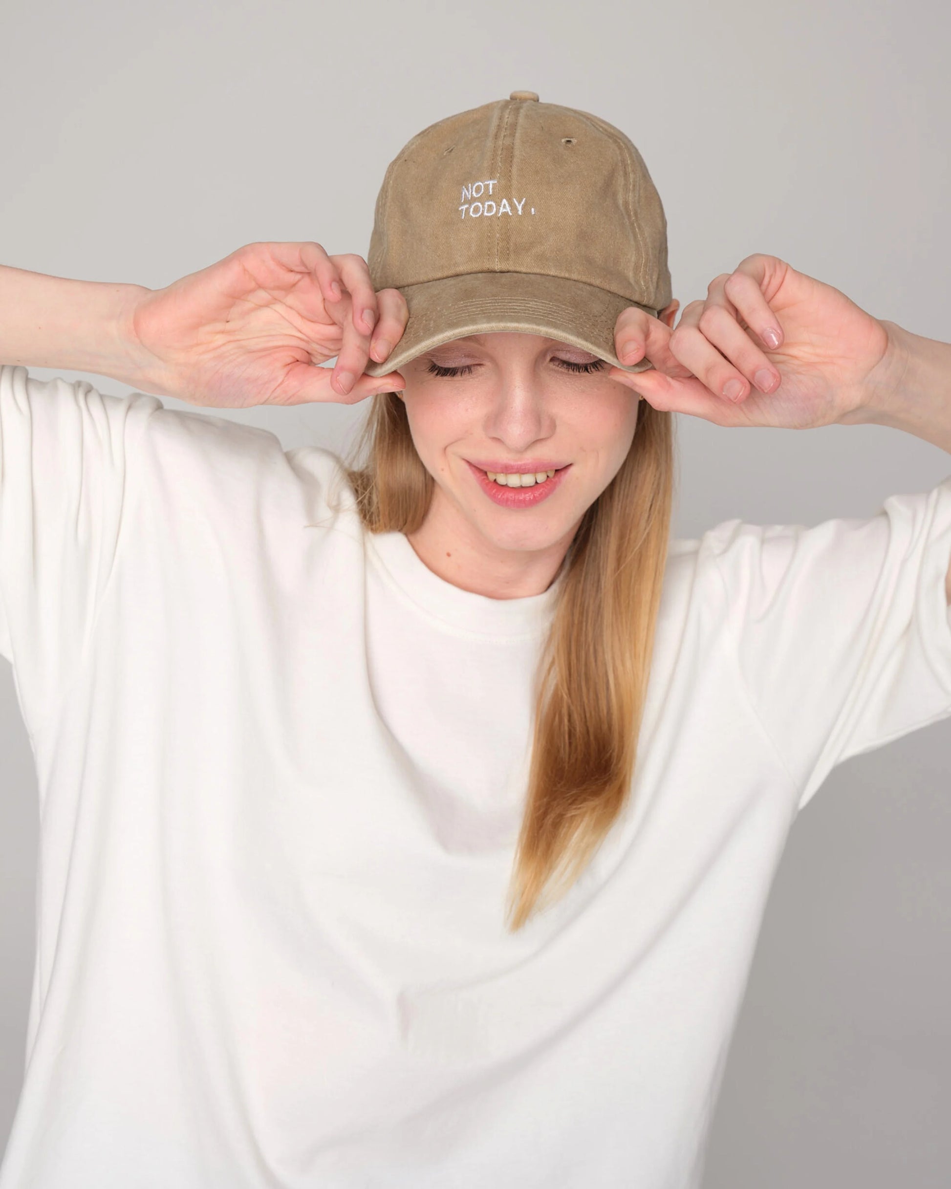 woman smiling and wearing Not Today Cream Washed Cap