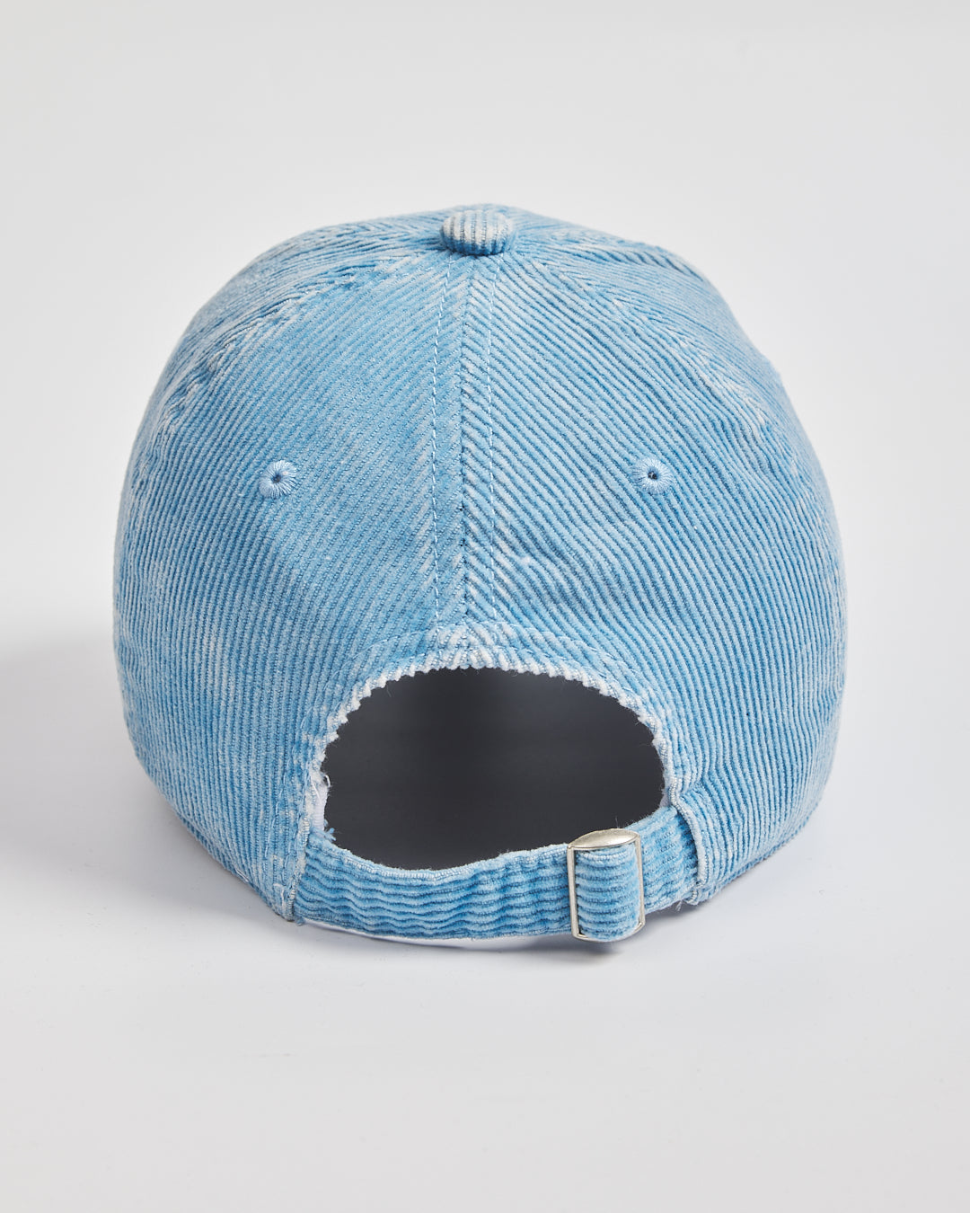 Light blue corduroy cap on a white background