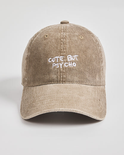 Beige cap with 'Cute But Psycho' text on a light gray background