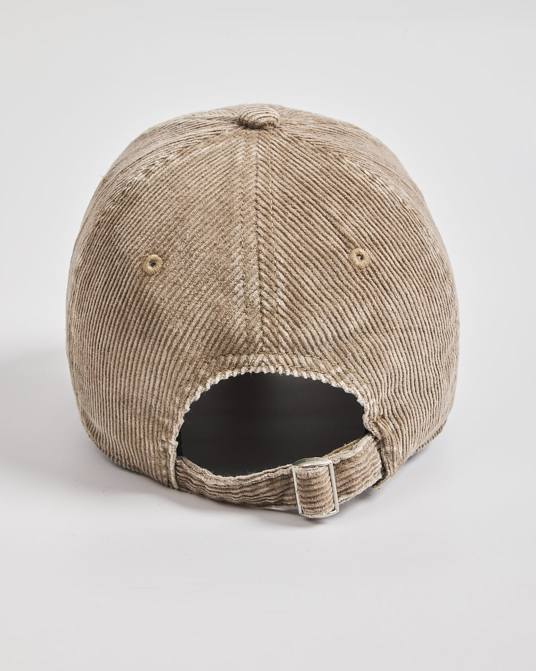 Beige corduroy cap on a light gray background