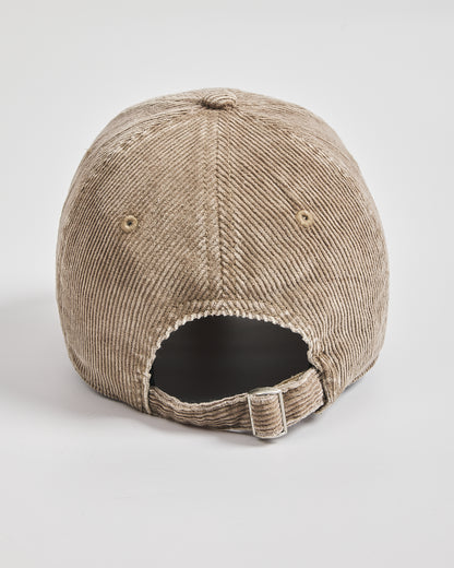 Beige corduroy cap on a light gray background