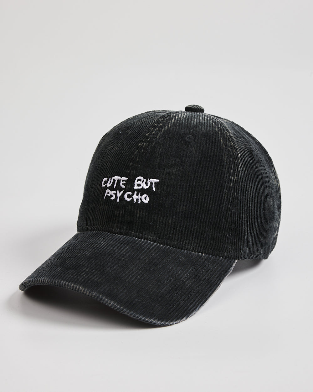 Black cap with 'Cute But Psycho' text on a light gray background