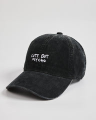 Black cap with 'Cute But Psycho' text on a light gray background