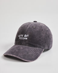Charcoal grey cap with 'Cute But Psycho' text on a light gray background