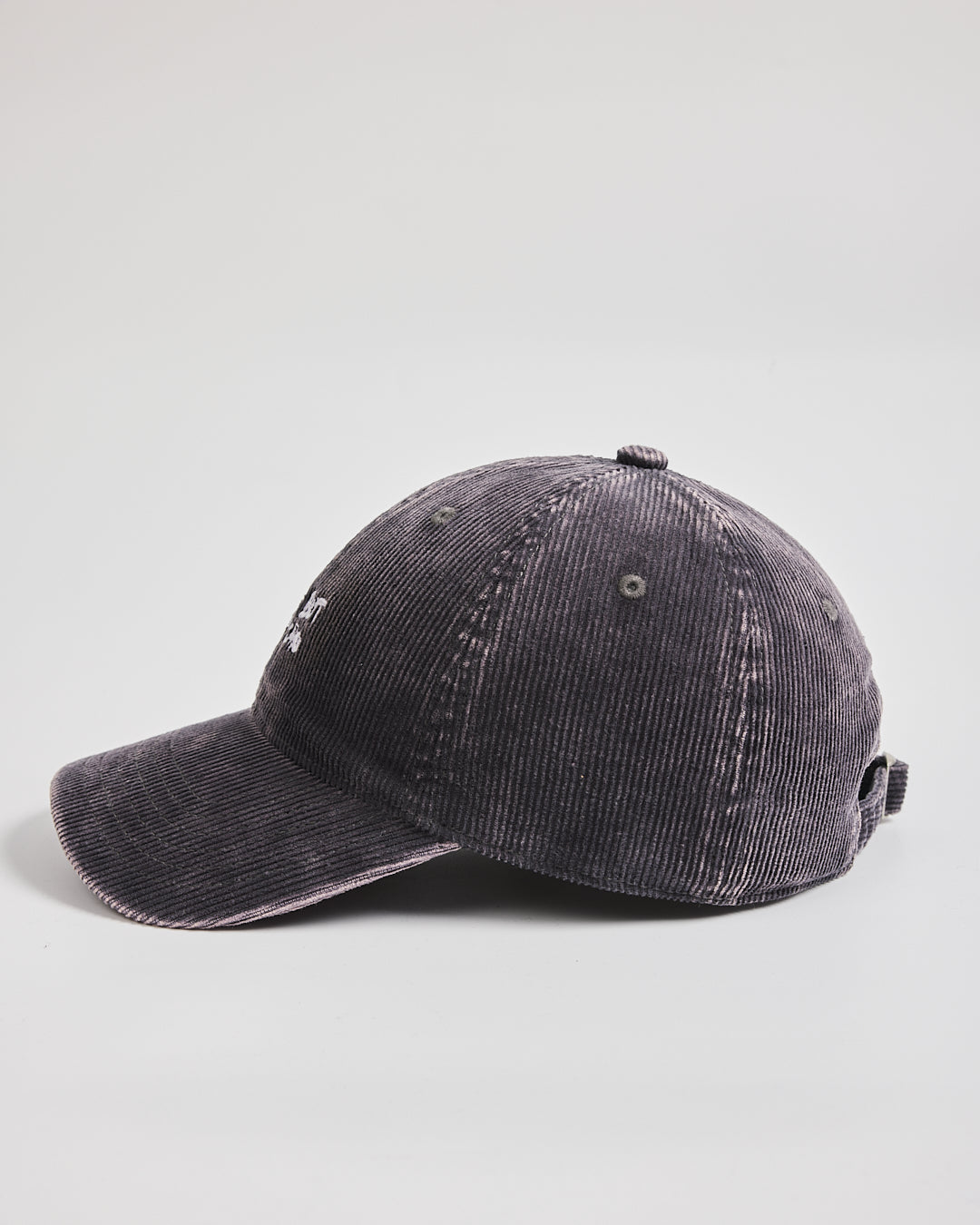 Side look of charcoal grey corduroy cap on a light gray background
