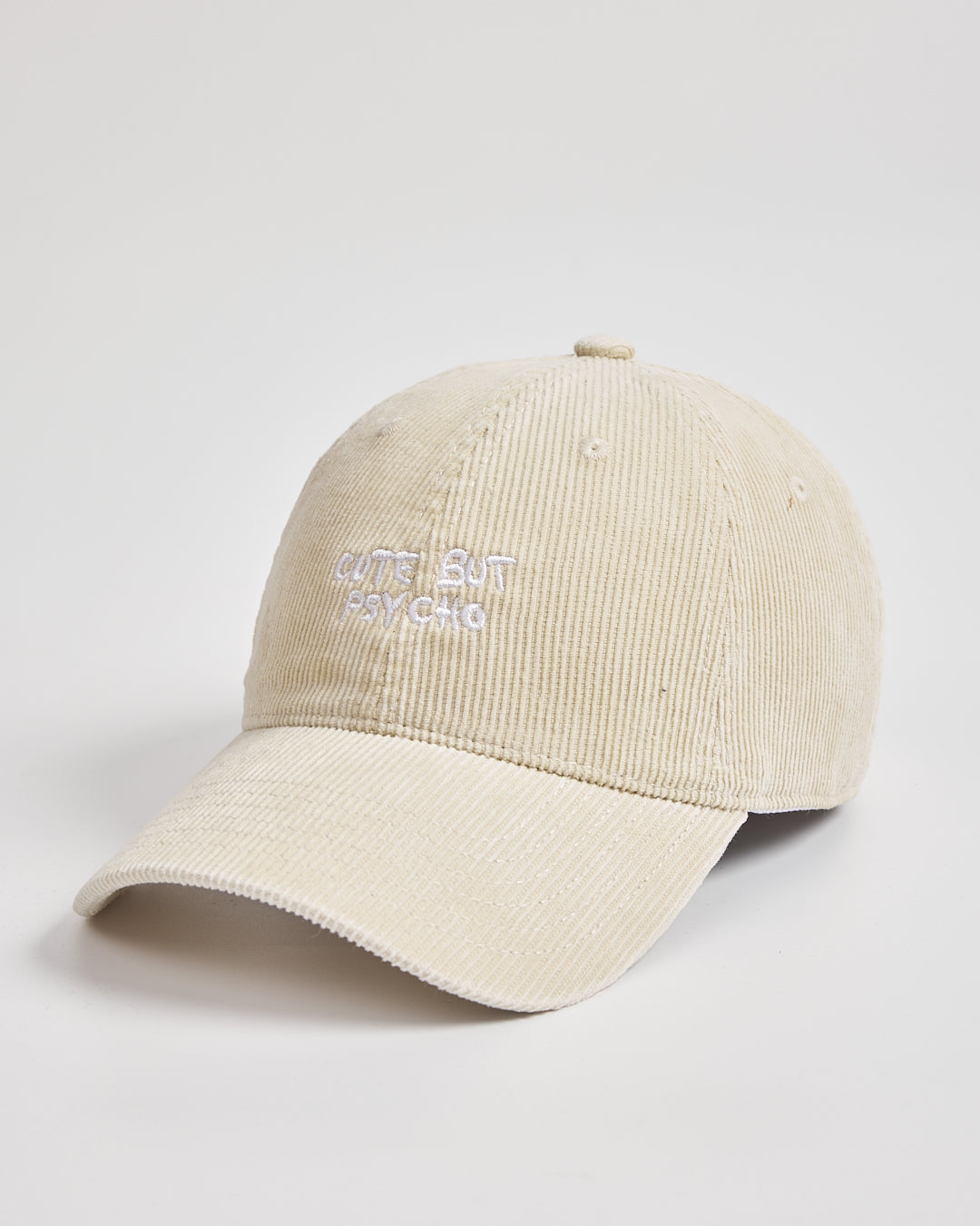 Cream corduroy cap with text on a light gray background