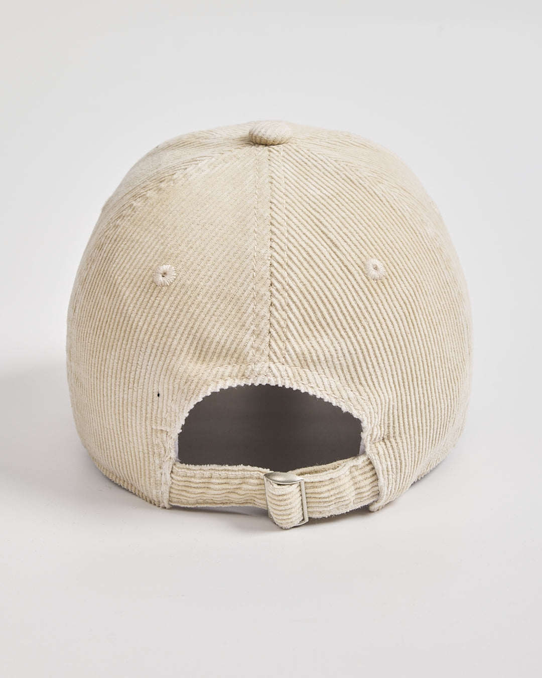 Cream corduroy cap on a light gray background