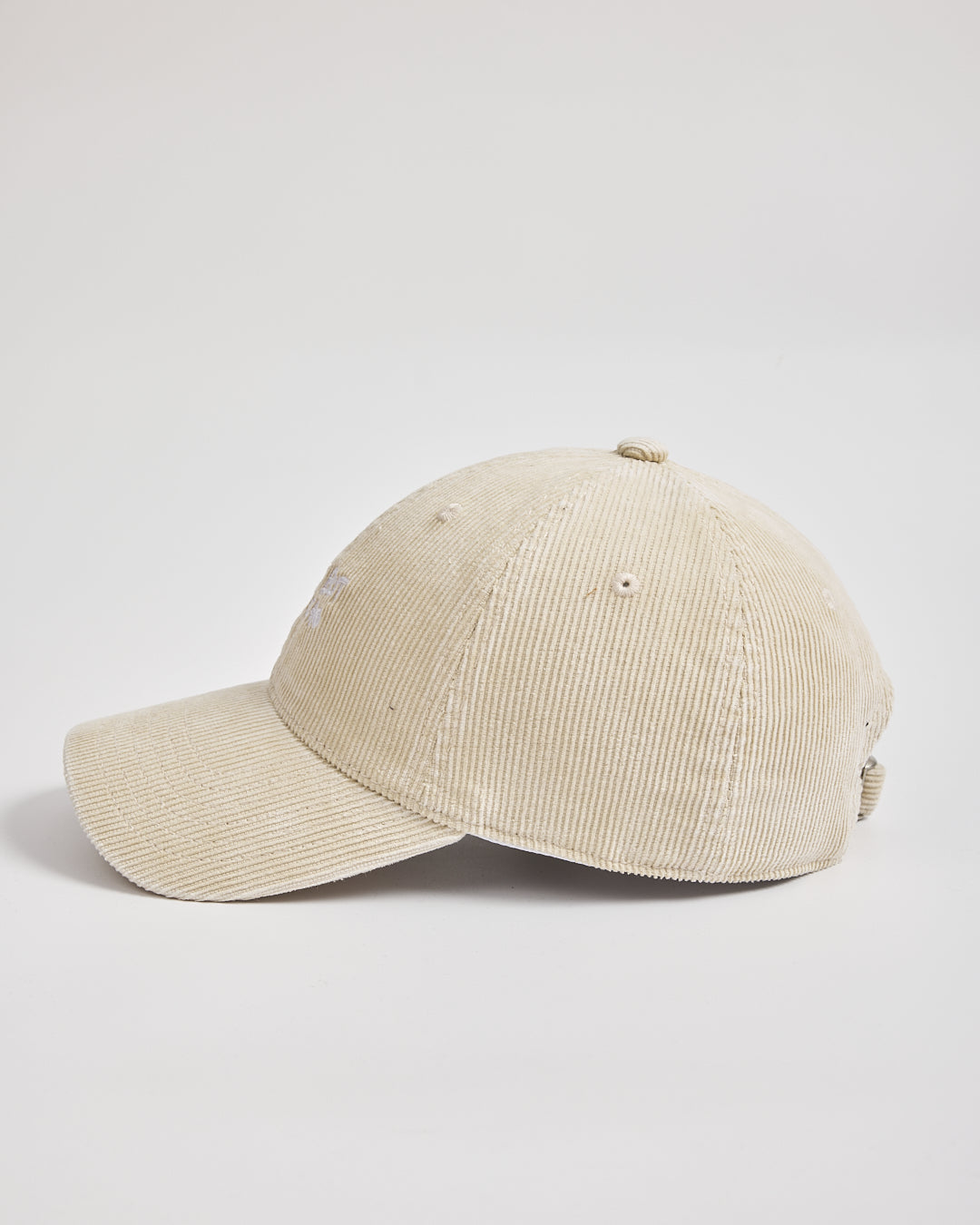 Cream corduroy cap on a light gray background