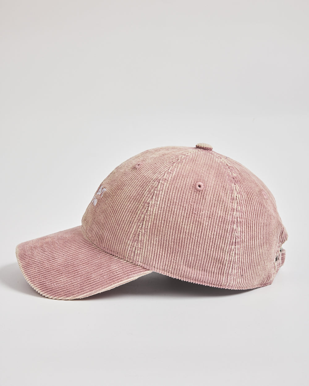 Pink corduroy cap on a light gray background