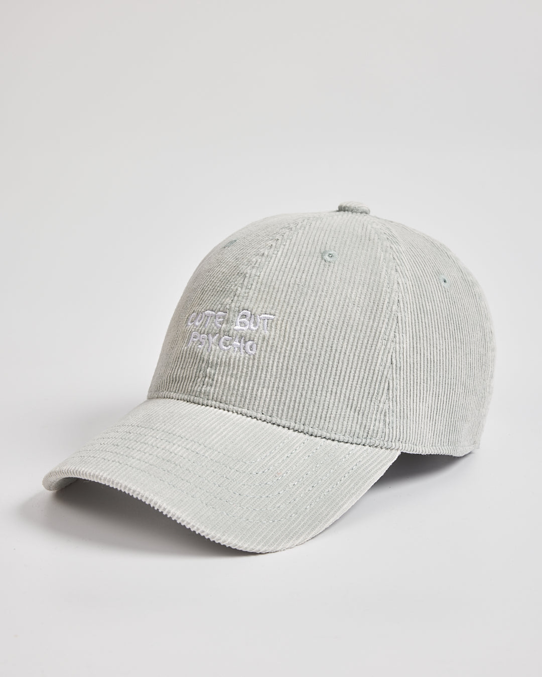 Side look of light grey Cute But Psycho cap with branding on a light grey background