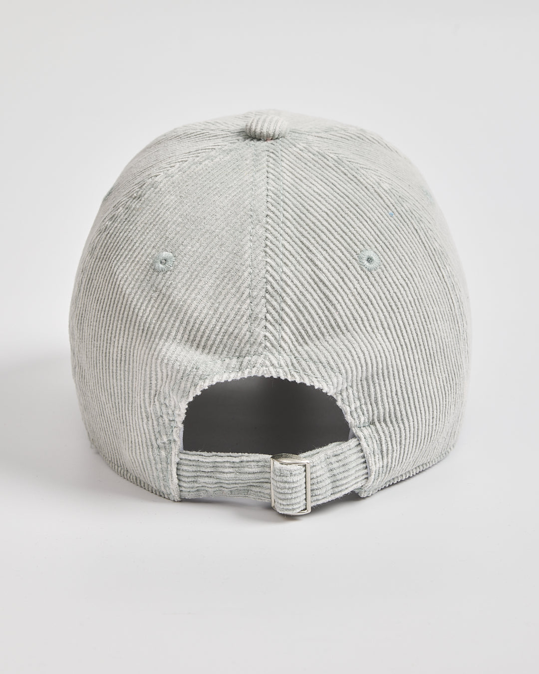 Back side of light grey corduroy cap with flip-tag on a white background