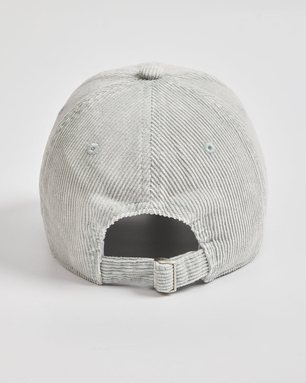Back side of light grey corduroy cap with flip-tag on a white background
