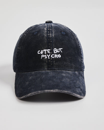 Navy Corduroy Cap with 'Cute But Psycho' text on a light gray background