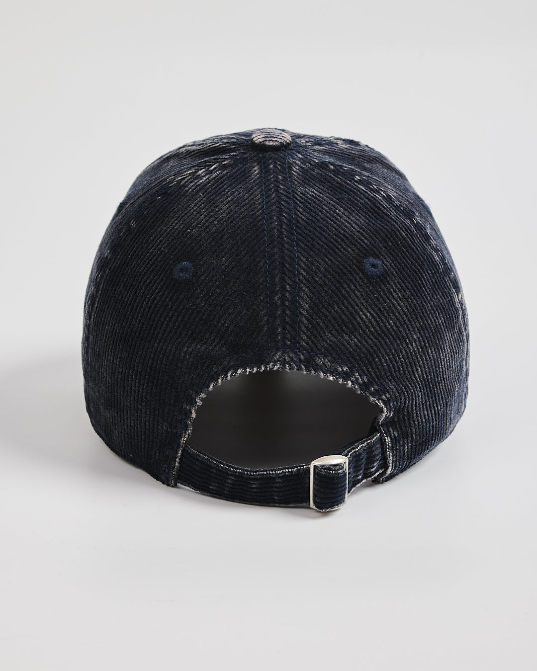 Navy corduroy cap on a light gray background