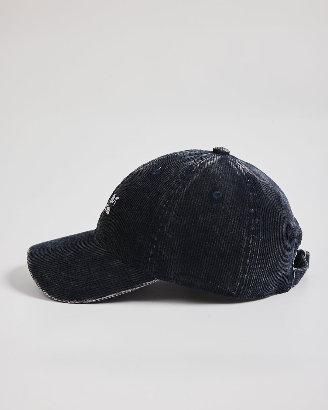 Navy corduroy cap on a light gray background