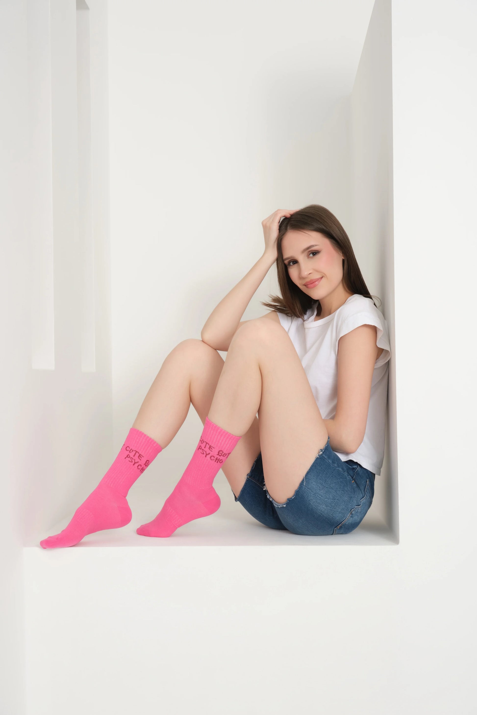 a model wearing hot pink cute but psycho socks