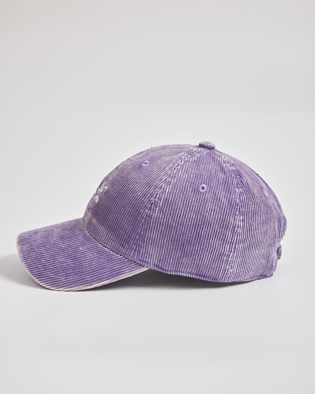 Purple corduroy cap on a light gray background