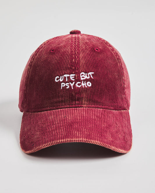 Red cap with 'Cute But Psycho' text on a light gray background