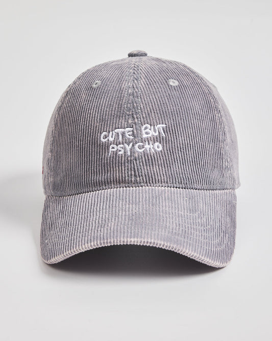 Gray corduroy cap with 'Cute But Psycho' text on a light gray background