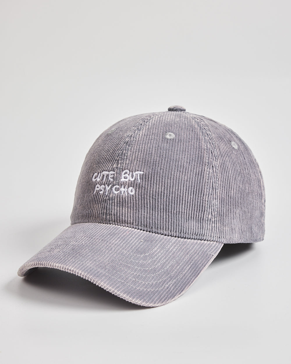 Gray cap with 'Cute But Psycho' text on a light gray background