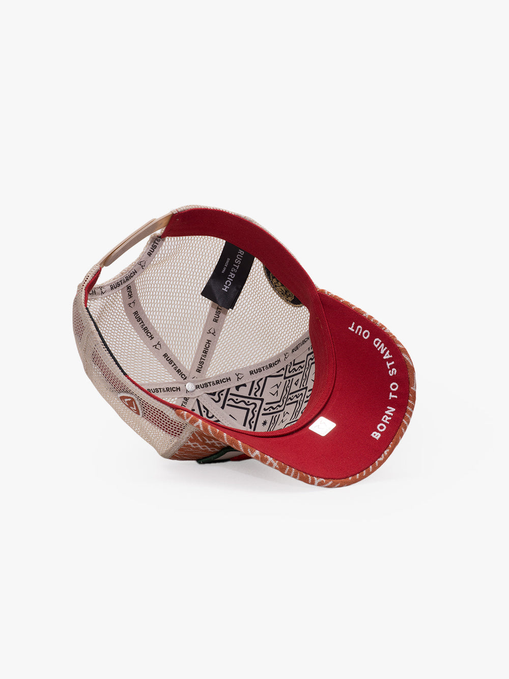 Red and beige cap with a patterned interior on a white background