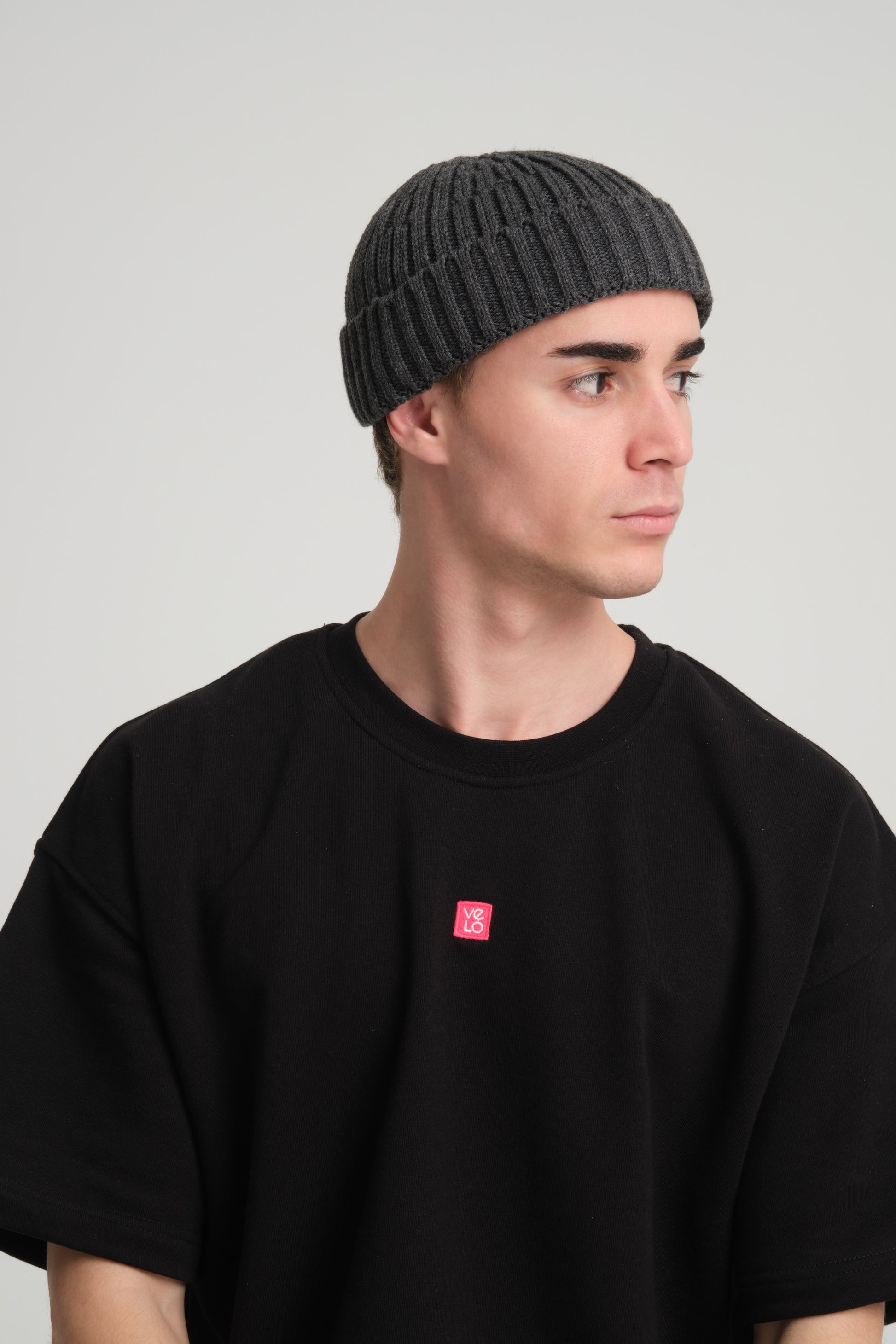 side view of a man wearing Dark Grey Fisherman Beanie