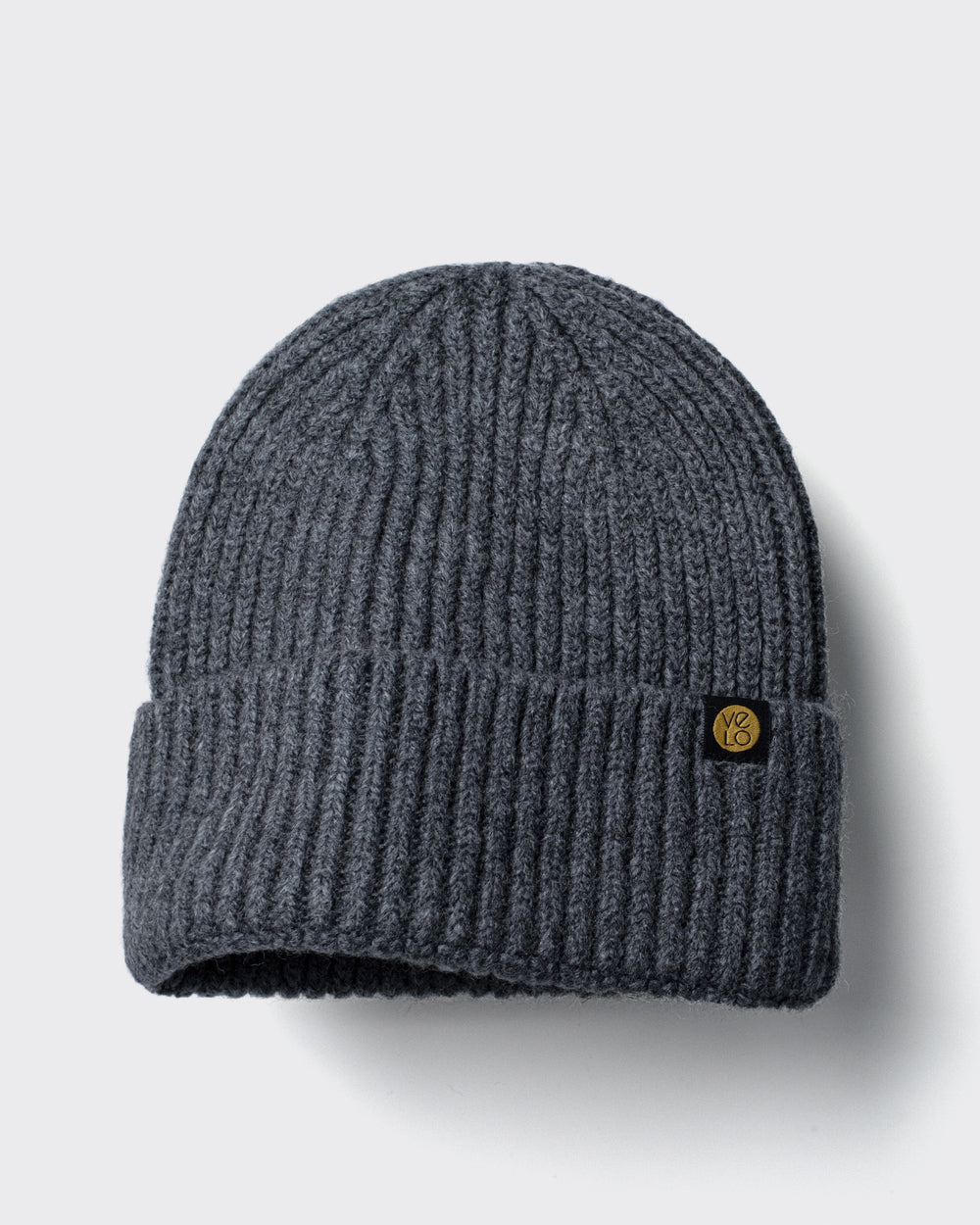 Dark Grey Lux Beanie on a light gray background