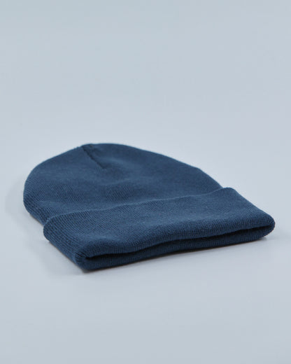 Dusty navy beanie on a light gray background
