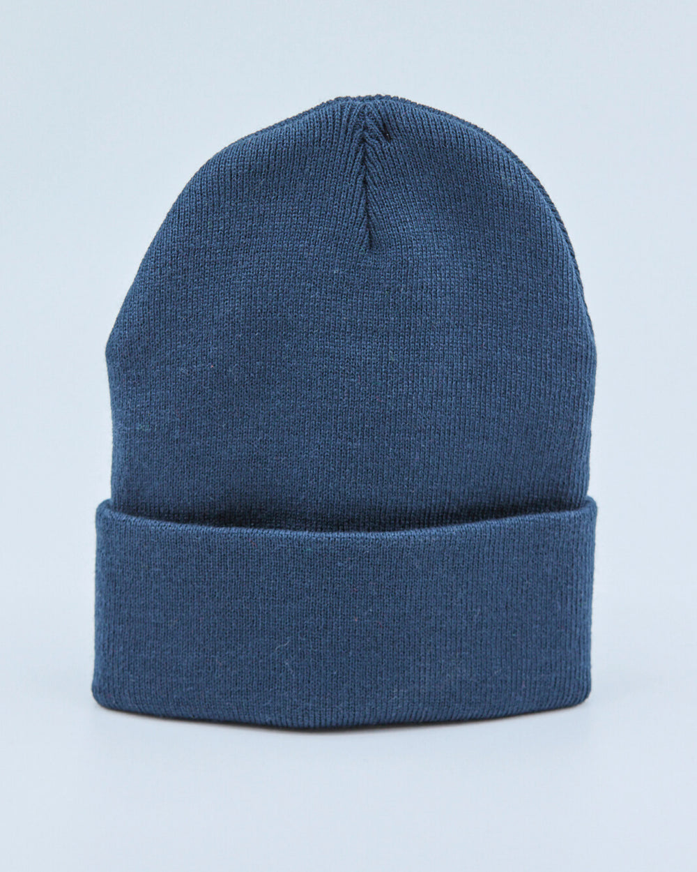 Dusty navy blue beanie on a light blue background