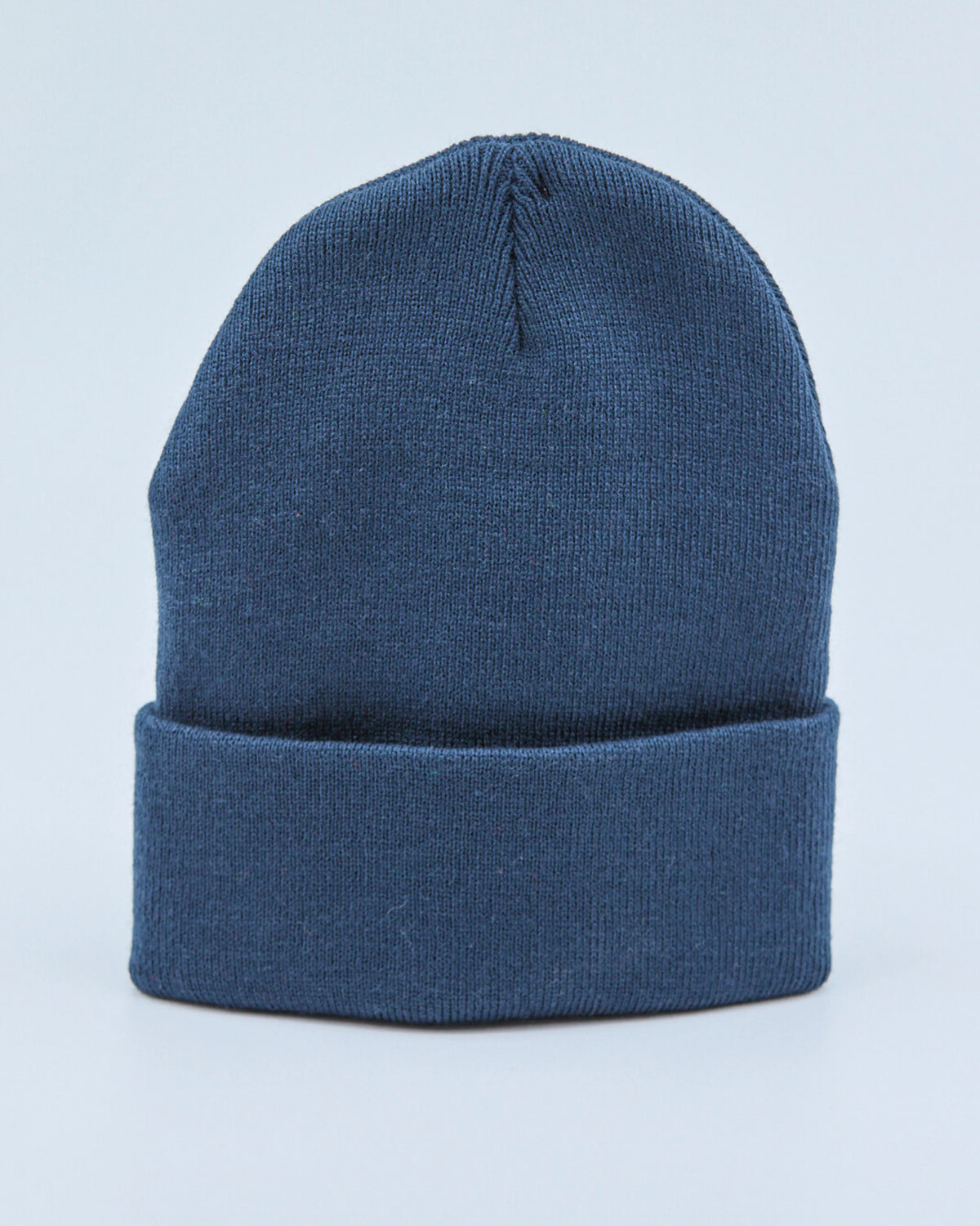 Dusty navy blue beanie on a light blue background