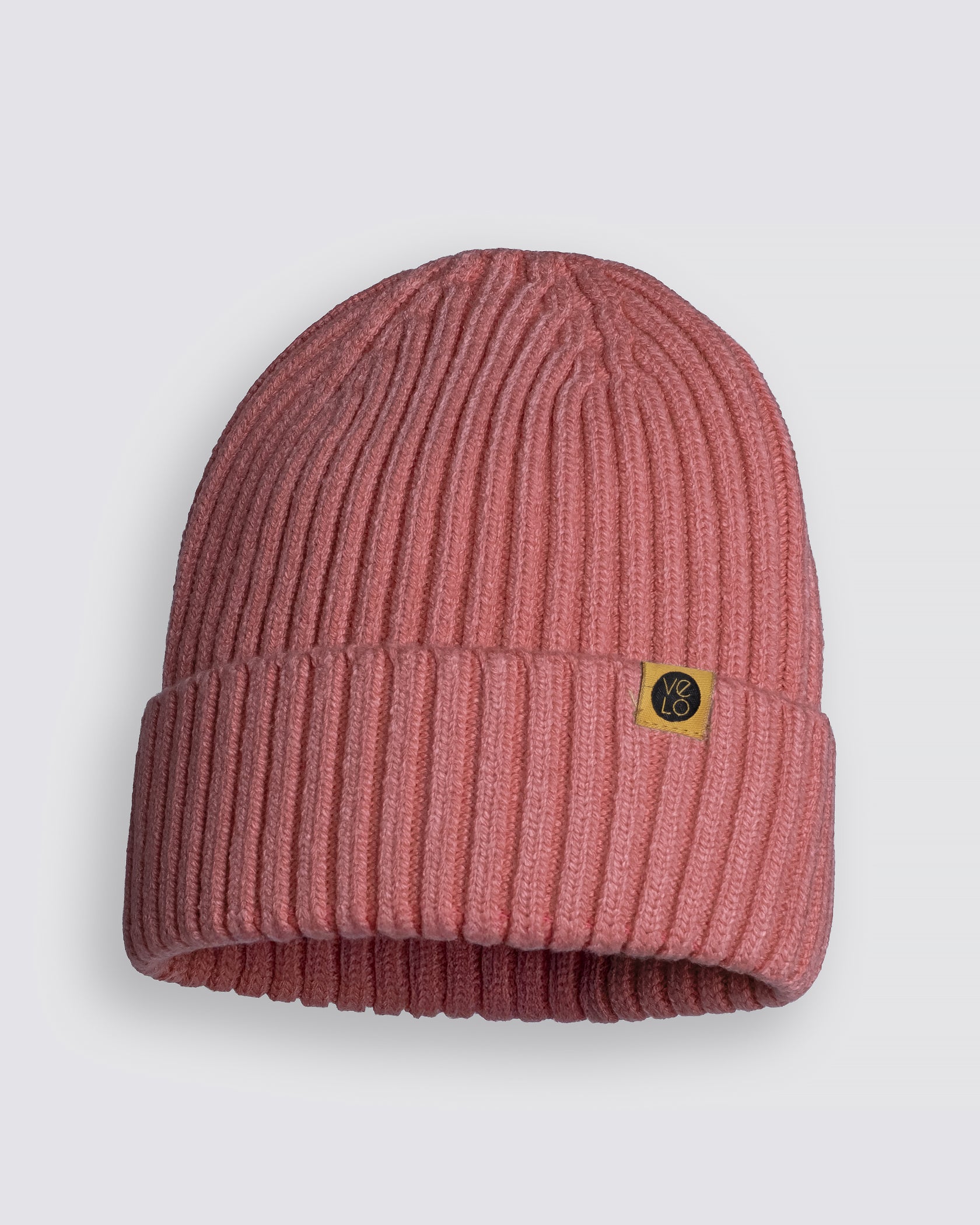 Dusty Pink Classic Beanie with a yellow tag on a light gray background
