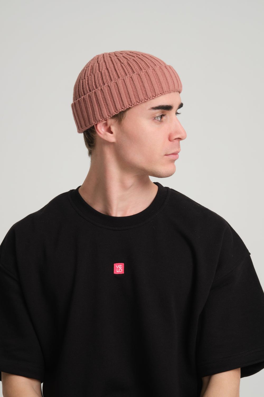 side view of a man wearing Dusty Pink Fisherman Beanie