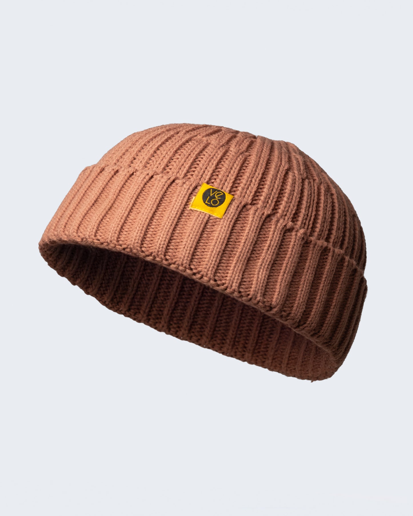 dusty pink fisherman beanie on a white background