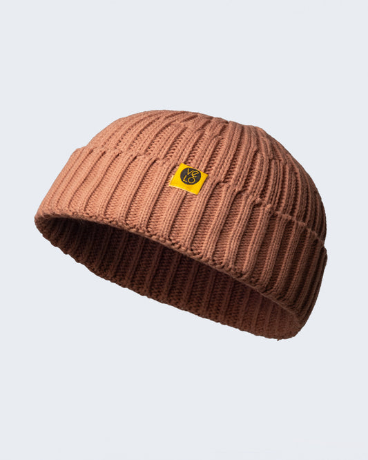 dusty pink fisherman beanie on a white background
