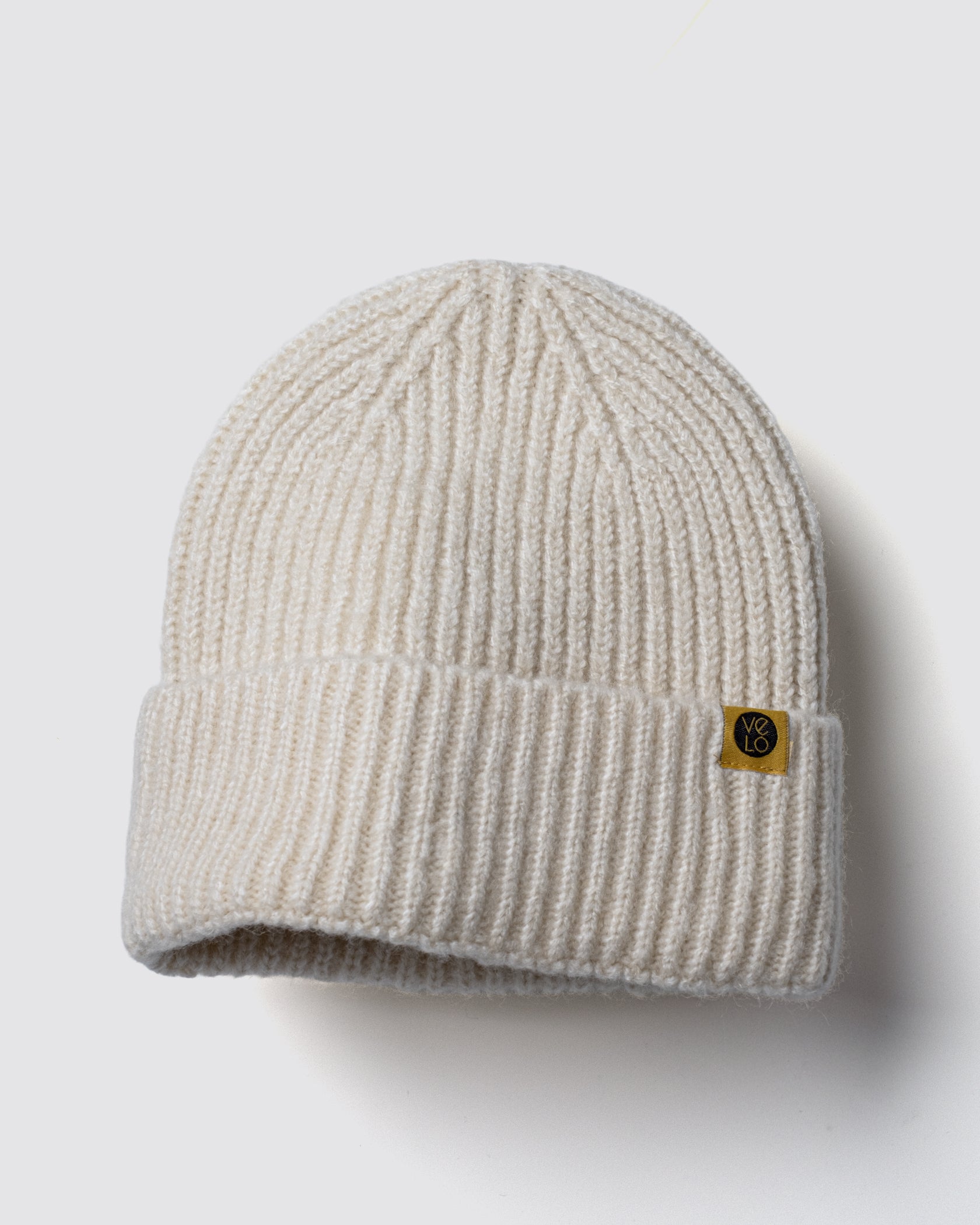 Ecru Lux Beanie on a light gray background