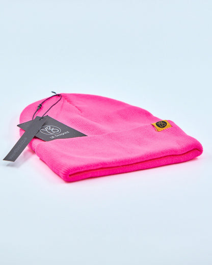 Fuschia pink beanie on a light gray background