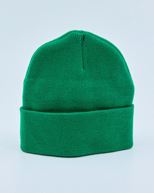 Green beanie on a light blue background